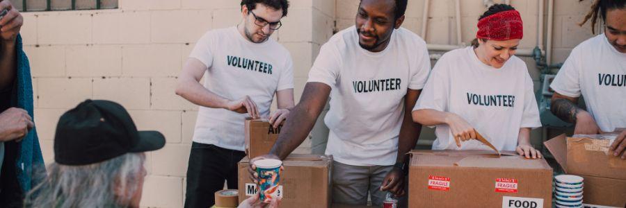 Volunteers distributing food and essentials to those in need on Do1Give Day, creating a positive impact through giving
