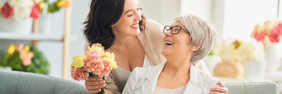 A daughter surprises her elderly mother with flowers—an act of love to celebrate Mom with joy and gratitude.