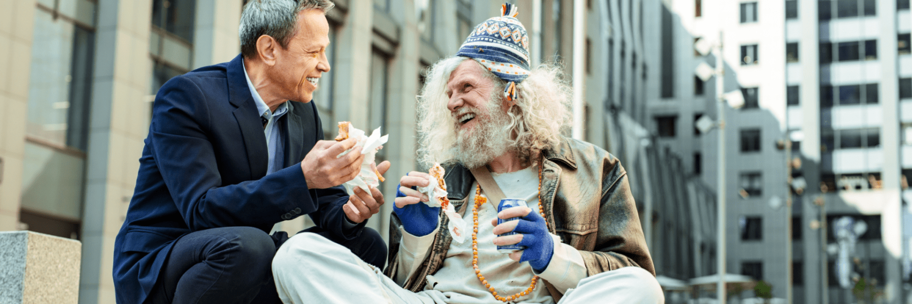 Businessman sharing lunch with a man in need as part of a mental health action plan through giving