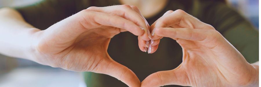 Hands forming a heart shape symbolizing heart-centered connection