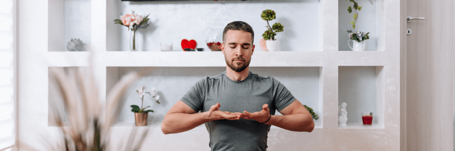 Man practicing mindfulness at home, showing that self-care is important for emotional balance and daily wellbeing.