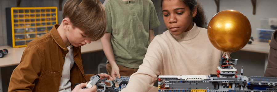 Students assembling a robotics model together, showcasing AI skills and teamwork in a learning environment