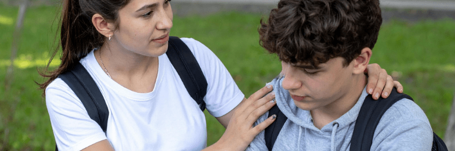 Teen showing empathy and support to a friend, highlighting peace education in everyday life.