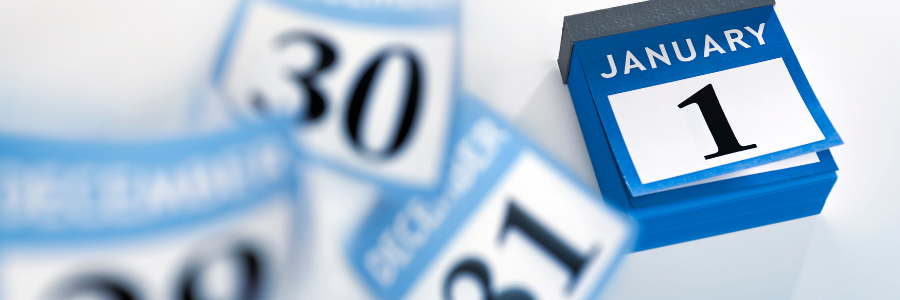 January calendar page showing January 1 on a blue desk calendar