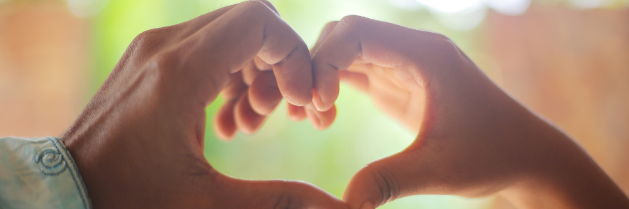 Two people forming a heart shape with their hands, symbolizing true love that’s shared not earned 