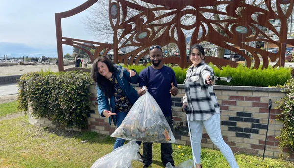 Volunteers participating in a community cleanup as part of a Do1Give Day act of giving.