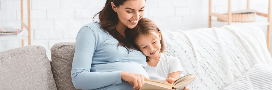 Child reading a free book at home inspired by women led philanthropy and early literacy giving