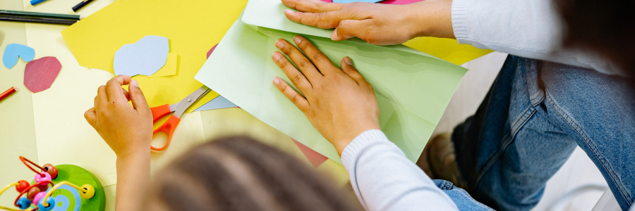 Students cutting and folding colorful paper notes for a happiness jar classroom activity that builds happy students