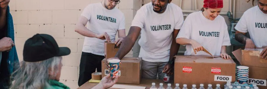 Volunteers giving food and supplies as part of Take Action Today community support
 